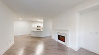 Located at 3770 George Busbee Pkwy in Kennesaw, GA, this well-appointed 3-bedroom, 2-bathroom single-floor residence offers a thoughtfully designed open-concept layout. The living room serves as a central gathering space, highlighted by a classic white-mantled electric fireplace, crown molding, and warm wood-look flooring that flows throughout the main areas. Large windows invite abundant natural light, creating a bright and airy atmosphere.

The kitchen is a standout feature, outfitted with crisp white shaker cabinets, quartz countertops, stainless steel appliances, a stylish peninsula with an undermount sink, and a skylight overhead that further enhances the sense of openness. It connects seamlessly to the dining area, making the space ideal for everyday living and entertaining. A pantry provides additional storage convenience.

The generously sized primary bedroom features vaulted ceilings, plush carpeting, a walk-in closet with built-in shelving, and direct access to a private en-suite bathroom. Secondary bedrooms are carpeted and include ceiling fans and windows with greenery views. The bathrooms are finished with neutral tile surrounds and soaking tubs. A dedicated laundry room with full-size washer and dryer hookups and a private balcony round out this comfortable home.