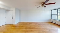 Located at 1 Woodbine Ave in Avenel, NJ, this well-appointed one-bedroom, one-bathroom residence offers a thoughtfully designed layout across a single floor. Warm hardwood flooring flows throughout the living areas and bedroom, creating a cohesive and inviting atmosphere. The open-concept living room is generously sized, filled with natural light through large windows that frame pleasant outdoor green views, and features a ceiling fan for added comfort. Baseboard heating is present throughout, ensuring year-round comfort. The kitchen is equipped with dark gray shaker-style cabinetry, marble-look countertops, a stainless steel refrigerator, gas range, built-in microwave, and dishwasher, all set on sleek tile flooring. A stacked washer and dryer unit is conveniently tucked behind louvered doors adjacent to the kitchen. The spacious primary bedroom features multiple windows with garden views, hardwood floors, and baseboard heating, providing a bright and comfortable retreat. The bathroom is finished with neutral large-format tile walls and flooring, a soaking tub with shower, a vanity with sink, and clean white fixtures. A hallway connects the rooms, completing this practical and move-in ready home.