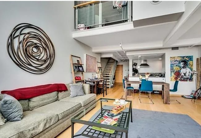 Living room with kitchen/entrance in back, as well as upstairs mezzanine BR - 25 Channel Ctr St