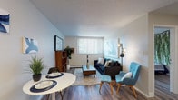 Located at 3802 Half Turn Rd in Colorado Springs, Colorado, this single-floor residence offers a thoughtfully laid-out living space with a cohesive, modern aesthetic throughout. The open living and dining area is anchored by wood-look flooring, a textured ceiling, and a large window fitted with vertical blinds that allows generous natural light to fill the room. The living area provides ample space for seating and a dining arrangement, making it both functional and inviting.

The kitchen features white upper cabinetry, a black range and refrigerator, and a light-toned countertop, all set against the same wood-look flooring that runs throughout the unit. Its efficient layout connects smoothly to the main living area.

The bedroom is a standout space, distinguished by a striking cascading greenery wall installation that serves as a dramatic natural focal point above the bed. A closet with louvered doors provides practical storage, and a window brings in additional natural light.

The bathroom is clean and functional, featuring a white vanity with a single-basin sink, a toilet, and a shower-tub combination with a curtain. Wood-look flooring and neutral wall tones carry through from the rest of the residence, maintaining a consistent design language.

Overall, the space presents a balanced blend of practicality and contemporary style, ideal for comfortable everyday living in Colorado Springs.