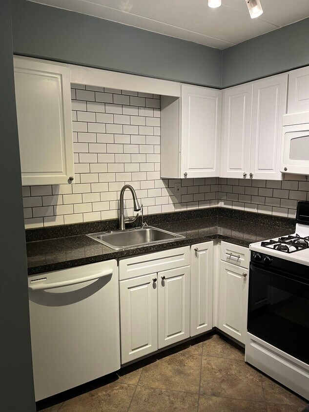 Kitchen equipped with dishwasher, gas stove and oven, microwave, and refrigerator - 5 Bayard Rd