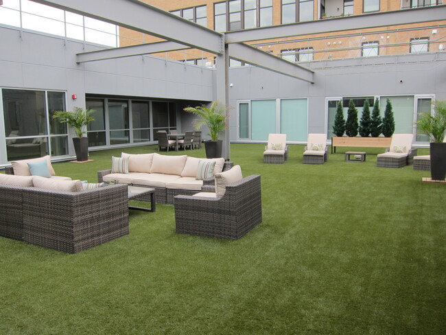 Outdoor courtyard common area for residents - Peregrine Plaza