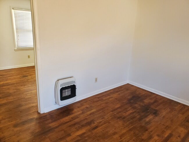 Living room with infrared gas heater. - 112 Oak St