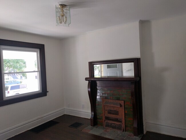 living room with ornimental fireplace - 254 E Gates St