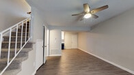 Located at 1613 Greenview Dr in Gastonia, NC, this two-story home offers a well-organized layout designed for comfortable everyday living. The main level features an open living area with durable hardwood-style plank flooring, neutral-toned walls, and a ceiling fan with integrated lighting. A staircase with white railings connects the two floors, adding a classic architectural touch to the space. The kitchen is thoughtfully appointed with white shaker-style cabinetry, granite-look countertops, a tile backsplash, and a full suite of black appliances including a refrigerator, range, dishwasher, and range hood. A window above the sink brings in natural light. Also on the main level is a half bathroom with a pedestal sink and hardwood-style flooring. Upstairs, the bedrooms are finished with plush neutral carpeting and feature windows with blinds that allow for natural light and privacy. The full bathroom on this level includes a tub-shower combination, hardwood-style flooring, and brushed nickel fixtures. Throughout the home, a consistent neutral color palette creates a clean and cohesive aesthetic, making the space move-in ready and easy to personalize.