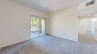 Located at 8000 Painted Desert Way in Roseville, CA, this 2-bedroom, 2-bathroom residence offers a thoughtfully designed single-level layout. The kitchen features white cabinetry with ample storage, a U-shaped configuration, wood-look flooring, and a full suite of white appliances including a refrigerator, range, and dishwasher — providing a clean, functional workspace. The open kitchen flows into the living area, which is carpeted and filled with natural light from sliding glass doors that lead to a private balcony overlooking lush, mature trees. Both bedrooms are carpeted and bright, each with windows that frame views of the surrounding greenery and neighborhood. The primary bedroom includes crown molding and direct access to the balcony, adding an elevated touch to the space. Two full bathrooms serve the residence — one featuring a soaking tub and single vanity with white cabinetry, the other a walk-in shower with a gold-framed glass enclosure and matching vanity. Both bathrooms are finished with warm wood-look flooring and well-lit mirrors. Throughout, the residence maintains a clean, neutral palette with white walls and consistent finishes, creating a bright and cohesive living environment.