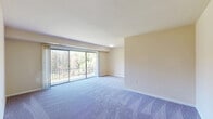 This single-floor, 2-bedroom, 1-bathroom unit at 5521 Marlboro Pike in District Heights, MD offers a practical and functional layout. The living room is a notable highlight, featuring large sliding glass doors that open to a private balcony overlooking a landscaped green area with mature trees, filling the space with natural light and providing pleasant outdoor views. The carpeted flooring throughout the living and bedroom areas adds warmth and comfort to the overall ambiance.

The galley-style kitchen is efficiently designed with white cabinetry, brown laminate countertops, a gas range, a full-size refrigerator, and wood-look flooring, maximizing every inch of available space. Both bedrooms are carpeted and finished with neutral-toned walls. The primary bedroom is a comfortable size and includes access to a dedicated closet with built-in shelving and hanging rods. The second bedroom features a wide window that brings in natural light and views of the surrounding area.

The single bathroom is clean and straightforward, equipped with a full tub-shower combination featuring white tile surround and chrome fixtures. Overall, the unit presents a simple, no-frills layout well-suited for efficient everyday living.