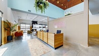Located at 1801 Diamond Pkwy in North Kansas City, MO, this dynamic single-floor amenity space spans a generously sized footprint across eight distinct areas, offering a well-rounded mix of social, recreational, and functional environments.

The centerpiece of the space is a bright, open lobby featuring soaring double-height ceilings, polished concrete floors, and bold, colorful murals — including a striking graphic wall that references the property's history. An open-plan kitchenette with a white quartz island, warm wood cabinetry, and bar seating in orange leather anchors the social hub of the lobby.

Adjacent to the lobby, a dining and lounge area offers a large natural wood table, modern upholstered chairs, pendant lighting, and a wall-mounted display screen, alongside a secondary kitchenette with stainless steel appliances. Private meeting rooms provide a quieter setting, decorated with curated artwork and carpeted flooring for acoustic comfort.

The game lounge features deep olive-green walls, a full-size pool table, track lighting, lounge seating, and windows overlooking the surrounding area — creating an inviting recreation space. A dedicated fitness center is equipped with commercial-grade cardio machines, strength training equipment, and rubber flooring, all bathed in natural light from large windows. The overall ambiance is modern, energetic, and thoughtfully designed to encourage community and activity.