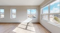 This contemporary 770 square foot apartment in Boston offers a thoughtfully designed living space with two bedrooms and one bathroom. The open-concept layout maximizes efficiency, seamlessly blending the kitchen, living, and dining areas. Large windows flood the rooms with natural light and provide stunning city views, creating an airy and expansive feel.

The kitchen boasts sleek white cabinetry, granite countertops, and modern appliances, perfect for culinary enthusiasts. Light wood-look flooring runs throughout, complementing the neutral wall tones and adding warmth to the space. The primary bedroom, measuring 130 square feet, offers ample space for relaxation.

The bathroom features a clean, modern design with a blue accent wall, white fixtures, and a combination tub-shower. Built-in storage solutions and recessed lighting add functionality and ambiance. Climate control systems ensure year-round comfort.

Located at 24 Heath St in Boston's vibrant 02130 zip code, this apartment combines urban convenience with contemporary style, making it an ideal home for those seeking a modern living experience in the heart of the city.