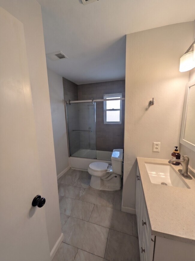 Baño en el pasillo con ducha y bañera. - 3006 Campbell Pl