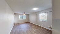 Located at 6710 Collins Rd in Jacksonville, Florida, this single-floor residence offers a well-designed layout with a clean, modern aesthetic throughout. The living areas are finished with warm wood-look laminate flooring and neutral-toned walls, creating a bright and welcoming atmosphere. Multiple windows allow generous natural light to flow through the space, while ceiling fans in the main rooms provide added comfort. Textured ceilings add a classic touch consistent throughout the home.

The kitchen is a standout feature, outfitted with crisp white cabinetry, granite-style countertops, a white subway tile backsplash, and stainless steel appliances including a range, over-the-range microwave, and refrigerator. A pass-through counter connects the kitchen to the adjacent living area, enhancing the open feel of the floor plan.

The bedroom areas mirror the rest of the home with consistent flooring, ceiling fans, and ample natural light from well-placed windows. The bathroom is finished with white square tile surrounding a full tub-shower combination, complemented by neutral walls and brushed nickel fixtures. Overall, the space presents a tidy, functional, and move-in ready interior suited for comfortable everyday living.