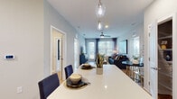 This well-appointed 2-bedroom residence in Jacksonville, Florida offers a thoughtfully designed single-story layout with modern finishes and a cohesive contemporary aesthetic. Light wood-tone flooring flows consistently throughout the space, providing warmth and visual continuity from room to room.

The kitchen serves as a central hub, featuring white shaker-style cabinetry, stainless steel appliances, a herringbone tile backsplash, and a large island with a quartz countertop illuminated by a glass pendant light. The island transitions seamlessly into the open dining area, where additional pendant lighting creates an inviting atmosphere for meals and gatherings.

The living room is bright and welcoming, with multiple windows allowing generous natural light and views of the surrounding greenery. A ceiling fan adds comfort, while the open flow from dining to living maximizes the sense of space.

Both bedrooms are comfortably sized, each with wood-tone flooring and large windows that invite natural light. One bedroom features a bold accent wall, adding visual character. The bathrooms include white cabinetry with clean-lined hardware, framed mirrors, and light countertops. A dedicated in-unit laundry area with full-size washer and dryer and built-in shelving adds practical convenience.