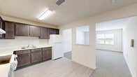 Located at 90 Hawkins Dr in Montgomery, NY, this one-bedroom, one-bathroom residence offers a well-organized single-floor layout designed for comfortable everyday living. The entrance leads into a functional hallway that connects the main living areas seamlessly.

The kitchen is a standout feature, equipped with rich dark-espresso cabinetry, white light-toned countertops, a white appliance suite including a range and refrigerator, and a tile backsplash. Light wood-style flooring runs throughout the kitchen, which opens toward the living room through a pass-through cutout, creating an airy, connected feel.

The living room is carpeted and benefits from natural light, providing a comfortable and versatile space. The generously sized bedroom also features plush carpeting and a large window that brings in natural light and outdoor views. Three closets serve the unit, including a walk-in closet outfitted with wire shelving and hanging rods for ample storage.

The bathroom includes light tile flooring, a glass-door shower, a vanity, and a toilet, finished in a clean, neutral palette. Throughout the residence, the consistently neutral color scheme and modern finishes create a bright, move-in-ready atmosphere.