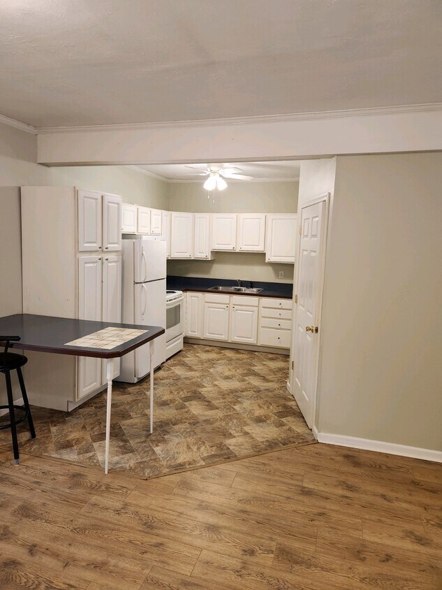 The kitchen boasts ample cabinets, a convenient kitchen island, and a spacious storage pantry - 224 River Rd