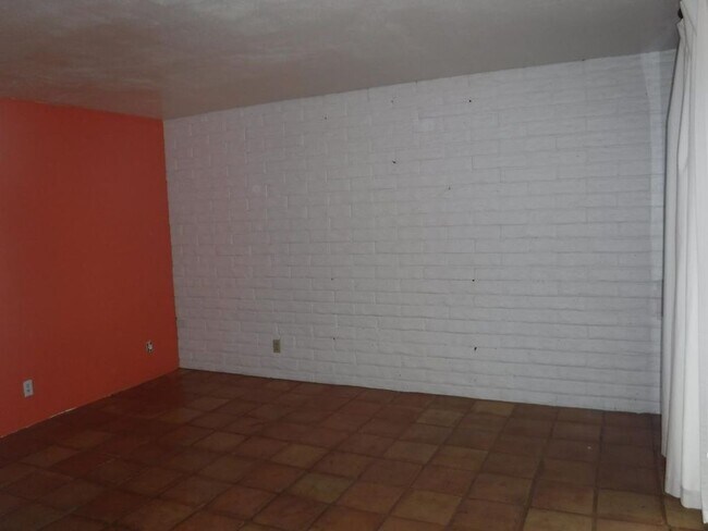 master bedroom with painted brick and tile floors. (sorry for bad lighting) - 5246 N 20th St