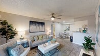 Located at 1500 East Broadway Road in Tempe, Arizona, this single-floor, 2-bedroom, 2-bathroom residence offers a thoughtfully designed layout suited for comfortable everyday living. The open-concept main area seamlessly integrates the living room, dining area, and kitchen, all finished with wood-style flooring throughout. The living room features a ceiling fan, textured ceilings, and a sliding glass door that opens to a private outdoor patio, allowing for ample natural light. The kitchen is equipped with white shaker cabinets, granite countertops, a grey subway tile backsplash, stainless steel appliances, and a built-in pantry for added storage. Both bedrooms are bright and well-sized, with natural light provided by slatted windows. The primary bedroom includes a walk-in closet. Each bathroom continues the granite countertop theme with white cabinetry; one bathroom features a walk-in shower, while the other offers a full bathtub. Four closets across the unit provide generous storage. A connecting hallway ties the private and shared spaces together efficiently, completing this clean and cohesive single-level home.