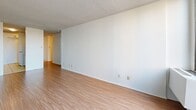 Located on Rue Prince-Arthur Ouest in the heart of Montréal, this one-bedroom, one-bathroom unit offers a practical and well-organized single-floor layout. The living room is bright and open, featuring warm laminate wood flooring, a textured accent wall, and large floor-to-ceiling sliding windows that flood the space with natural light and frame views of the surrounding Montréal cityscape. The bedroom is generously proportioned, also finished with laminate flooring, and includes a built-in sliding door closet, offering ample storage. A textured ceiling completes the room's clean, understated aesthetic. The galley-style kitchen is efficiently designed with white cabinetry on both sides, white appliances including a full-size refrigerator and dishwasher, a stainless steel sink, and light-toned tile flooring. Upper and lower cabinets provide solid storage capacity. The bathroom is functional and neatly finished, featuring a wide vanity with an under-sink cabinet, a large mirror, tile flooring, and a full bathtub with tiled surround. Overall, the unit presents a clean, neutral palette throughout, making it a practical and adaptable living space in one of Montréal's most sought-after neighbourhoods.