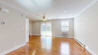 Located at 1911 Greve Ave in Spring Lake Heights, NJ, this well-appointed 2-bedroom, 1-bathroom single-floor home offers a comfortable and efficiently designed layout. Warm hardwood floors run throughout the entire space, creating a cohesive and inviting atmosphere from room to room.

The spacious living room is a standout feature, filled with natural light from a large sliding glass door that opens to a view of the backyard, complemented by an additional window with a wall-mounted A/C unit. Recessed lighting and a ceiling fan add both functionality and style to the room, which also benefits from crown molding and baseboard heating.

The kitchen has been thoughtfully updated with dark shaker-style cabinetry, white countertops, a subway tile backsplash, and a full suite of stainless steel appliances including a refrigerator, dishwasher, range, and microwave. Recessed lighting and crown molding complete the polished look.

Both bedrooms continue the hardwood flooring and neutral color palette, with ceiling fans, baseboard heating, and wall A/C units. The primary bedroom includes a closet with built-in shelving. The bathroom is clean and modern, featuring large-format tile, a glass-enclosed walk-in shower, and a window for natural light.