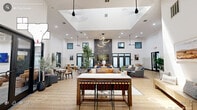Located at 1400 E Cornwallis Rd in Durham, NC, this thoughtfully designed community space offers a sophisticated blend of modern architecture and functional versatility across a single, expansive floor. The entrance welcomes visitors with soaring double-height ceilings, warm wood-look flooring, shiplap wall accents, and an abundance of natural light streaming through oversized glass doors and clerestory windows. The grand living room serves as the heart of the space, featuring dramatic vaulted ceilings, a striking floor-to-ceiling tile fireplace wall, pendant lighting, and multiple seating arrangements ideal for gathering and collaboration. Two distinct dining areas provide flexible options — one equipped with a large communal table, a coffee station, a barn-style sliding door, and patterned accent wallpaper, while the other offers a long conference-style setup with curated artwork and rich blue two-tone walls. The private office features bold navy shiplap walls, built-in wood shelving, plush carpeting, and a large window overlooking outdoor greenery. An additional conference room with a round table and wall-mounted display provides a dedicated meeting environment. Throughout, a cohesive palette of navy, warm wood tones, and crisp white creates a polished, inviting atmosphere.