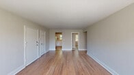 This 2-bedroom, 1-bathroom apartment at 800 N Broad St in Elizabeth, NJ offers a thoughtfully designed single-floor layout that makes efficient use of its space. The open living room greets residents with warm hardwood flooring, neutral walls, and natural light filtering through multiple windows, creating a bright and welcoming atmosphere. Classic radiator heating units are integrated throughout, nodding to the building's enduring character.

The kitchen features white shaker-style cabinetry, marble-look quartz countertops, and stainless steel appliances, providing a clean and functional cooking space with a window that brings in additional natural light.

Both bedrooms are carpeted in soft gray, offering comfort underfoot. The spacious primary bedroom is generously sized, featuring large windows with abundant natural light and radiator heating. The second bedroom provides a cozy, versatile space suitable for a guest room or home office.

The bathroom is a standout feature, showcasing a full soaking tub surrounded by elegant large-format marble-patterned tile in white and gold tones, lending a refined, upscale feel to the space.

A connecting hallway links the rooms seamlessly, and the overall neutral color palette throughout lends a clean, move-in-ready aesthetic to this well-maintained Elizabeth apartment.