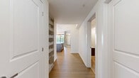 Located at 78-80 Rue Dollard-Des-Ormeaux in Gatineau, this generously sized 3-bedroom, 1-bathroom unit offers a thoughtfully designed single-floor layout with a bright, contemporary aesthetic throughout. Light hardwood flooring flows seamlessly across the open-concept living and kitchen area, anchored by striking exposed concrete columns that add an industrial character to the modern design. The kitchen is well-appointed with white upper cabinetry, two-tone lower cabinets, stainless steel appliances, subway tile backsplash, and a large central island with pendant lighting — ideal for both cooking and entertaining. The living area is bathed in natural light, thanks to expansive floor-to-ceiling windows and sliding glass doors that open to a balcony with open views of the surrounding neighbourhood. Each of the three bedrooms is finished with the same warm hardwood flooring and features large black-framed windows that maximize natural light. The primary bedroom includes a dedicated closet. The full bathroom is elegantly finished with large-format tile, a soaking tub, a glass-enclosed walk-in shower, and a modern vanity. A dedicated in-unit laundry room with stacked washer and dryer adds everyday convenience to this well-rounded space.