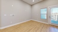 Located at 5808 Nall Ave in Mission, Kansas, this thoughtfully designed one-bedroom, one-bathroom residence offers a efficient and modern single-floor layout. The open-concept living area seamlessly connects the dining room, kitchen, and living room, creating a bright and functional communal space. The kitchen is a standout feature, boasting crisp white shaker cabinetry, granite-style countertops, a central island with an undermount sink, and a full suite of stainless steel appliances including a range, microwave, refrigerator, and dishwasher. Light wood-style flooring runs throughout the main living areas, complementing the neutral gray walls and recessed lighting overhead. The spacious bedroom is carpeted for comfort, features a ceiling fan, and includes access to a well-sized closet. The full bathroom is finished with white cabinetry, granite-style countertops, wood-look flooring, and a tub-shower combination. A dedicated in-unit laundry room comes equipped with a full-size washer and dryer. Additional storage is provided through two closets and a utility room. The unit also includes a private outdoor balcony with open views, offering a pleasant retreat. Natural light flows throughout the space via multiple windows.