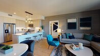 Located at 4499 Ohio St in San Diego's vibrant 92116 neighborhood, this single-floor residence showcases a thoughtfully designed open-concept layout with modern finishes and a cohesive cool-toned aesthetic throughout. The living area is anchored by textured accent walls, wood-look flooring, and large windows that frame expansive views of the surrounding cityscape, with direct access to an outdoor balcony that invites natural light deep into the space. The kitchen features light wood cabinetry, white quartz countertops, a classic subway tile backsplash, stainless steel appliances including a gas range, and a breakfast bar with seating — ideal for both casual dining and entertaining. Two well-proportioned bedrooms each offer large windows with sweeping neighborhood views and are appointed with light wood flooring and ample natural light. The primary bathroom includes a dual-sink vanity with light wood cabinetry and a soaking tub-shower combination, while the second bathroom mirrors the same clean, modern design with a single-sink vanity and tub-shower combo. Warm lighting, recessed fixtures, and consistent use of light wood tones unify the space, creating a bright, contemporary atmosphere throughout.