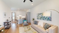 Located at 1805 Castle Dr in Garland, TX, this well-designed two-story home offers 2 bedrooms and 3 bathrooms across two thoughtfully laid-out floors. The main floor serves as the heart of the home, featuring a bright, open-concept living, dining, and kitchen area. The living room is filled with natural light through large windows flanking a modern glass-panel front door, complemented by warm hardwood-style flooring and a ceiling fan. The kitchen is a standout, boasting white upper cabinets, gray lower cabinetry, stainless steel appliances, under-cabinet lighting, and a large center island with bar seating — ideal for both cooking and entertaining. A patio off the main level provides a private outdoor retreat with a fenced yard and turf lawn. An attached garage and dedicated laundry area add everyday convenience. Upstairs, the bedrooms are finished with plush carpet and ceiling fans. The primary bedroom includes an en-suite bathroom featuring a dual-sink vanity with white quartz countertops, hardwood-style flooring, and sleek matte black fixtures. Three closets throughout the home ensure ample storage. Clean white walls and recessed lighting create a bright, cohesive aesthetic throughout.
