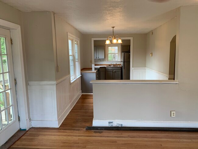 Living room into dining room and kitchen. - 1305 W Broadway