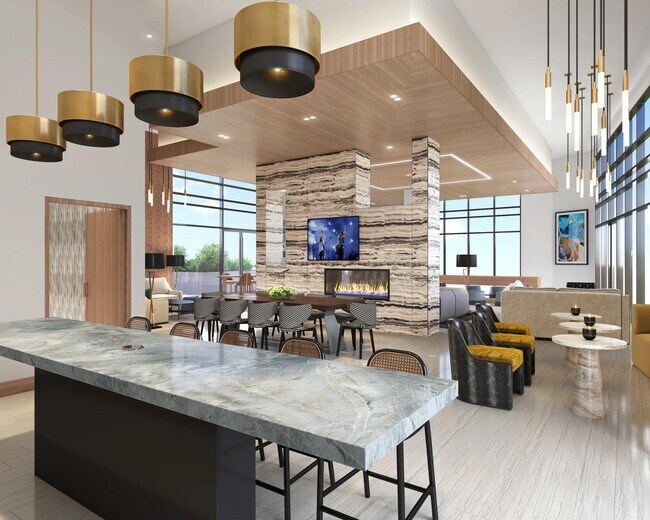 Salón en el piso 29 en los apartamentos Modera McGavock con espacio para reuniones, cocina de demostración y asientos cómodos. - Modera McGavock