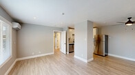Located at 1163 Hopper Ave in Santa Rosa, CA, this thoughtfully designed one-bedroom, one-bathroom unit offers a clean, modern living experience across a single floor. The open-concept living room and kitchen area is bathed in natural light from large windows with blinds, complemented by recessed lighting and light wood-style luxury vinyl flooring that runs throughout the entire space. A wall-mounted mini-split system provides efficient heating and cooling. The kitchen is well-appointed with white shaker cabinetry extending to the ceiling, light stone countertops, a stainless steel dishwasher, range, and refrigerator, along with a single-basin sink. Neutral gray walls create a calm, cohesive aesthetic throughout. The bedroom is a comfortable, well-proportioned room featuring its own window with natural views, recessed lighting, a mini-split unit, and access to a dedicated closet. The bathroom is clean and functional, offering a full tub-shower combo with built-in shelving, a white vanity with a stone-topped countertop, and matching light wood flooring. The unit's fresh, move-in-ready condition and modern upgrades make it a practical and attractive home in the heart of Santa Rosa.