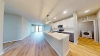 This contemporary residence in Elgin, IL offers 1,980 square feet of thoughtfully designed living space across two floors. The home boasts four bedrooms, including a sprawling 540 square foot primary suite, and two well-appointed bathrooms. The heart of the home is an open-concept kitchen and living area, featuring a sleek design with white cabinetry, stainless steel appliances, and a large center island. Hardwood floors flow throughout the main living spaces, while plush carpeting adds comfort to the bedrooms. Large windows in every room flood the space with natural light, creating an airy and inviting atmosphere. The bathrooms showcase modern fixtures and finishes, including a glass-enclosed shower and ample storage. A separate laundry area adds convenience to daily living. The home's exterior offers outdoor living potential with a balcony accessible from one of the upper-level rooms. With its blend of style and functionality, this property presents an ideal living solution for those seeking a contemporary home in a desirable location.