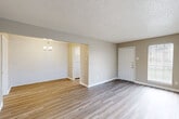 Located at 1717 College St in Houston, TX, this single-story, one-bedroom, one-bathroom home offers a well-organized layout across a compact and efficient floor plan. Light-toned wood-look flooring runs consistently throughout the space, contributing to a clean and cohesive aesthetic.

The living room welcomes you at the entrance, featuring two windows with blinds that allow natural light to brighten the room, complemented by a textured ceiling. It opens directly into the dining area, which is distinguished by a striking white-painted brick accent wall and a pendant chandelier overhead — a standout architectural detail that adds character.

The kitchen is functional and well-appointed with white cabinetry, light countertops, a stainless steel double sink, and a white electric range, all brightened by a window above the counter. An adjacent pantry provides additional storage.

The bedroom offers a comfortable footprint, highlighted by a ceiling fan and a sliding glass door that opens to a private rear patio with wood fencing. The full bathroom is bright and clean, featuring a tub/shower combo and a window for natural ventilation. Three closets throughout the home ensure ample storage. A hallway connects the primary spaces, completing this practical and inviting single-floor layout.
