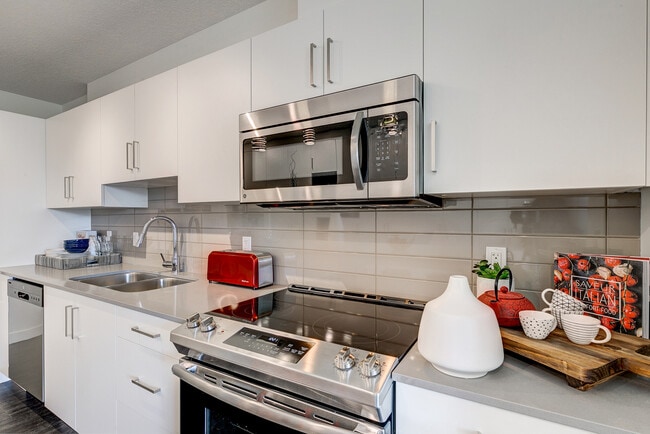 Stainless Steel Kitchen and Backsplash Design - e11even