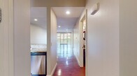 Located in the Chenal Woods neighborhood of Little Rock, Arkansas, this single-floor residence offers a well-designed layout with a clean, modern aesthetic throughout. The open living area is anchored by rich, polished hardwood floors that reflect abundant natural light, creating a bright and welcoming atmosphere. French doors lead to a private balcony, seamlessly connecting the interior to the outdoors.

The kitchen is outfitted with granite countertops, rich dark wood cabinetry, stainless steel appliances including a gas range and dishwasher, and under-cabinet lighting that highlights the quality finishes. A pass-through connects the kitchen to the main living space, enhancing the open feel.

A central hallway, also finished in hardwood flooring, links the living areas to the private quarters. The bedrooms feature neutral-toned carpet, ceiling fans with integrated lighting, and windows that bring in natural light. The primary bathroom includes a granite-topped vanity with dark wood cabinetry, tile flooring, a walk-in closet, and a glass-enclosed shower. Recessed lighting throughout the home contributes to a polished and cohesive interior. The overall layout is practical and efficient, offering comfortable living in a well-appointed single-level floor plan.