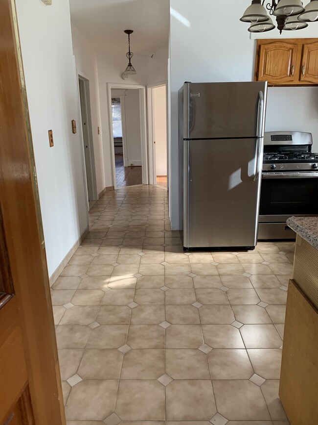 kitchen leading to other rooms (bedroom 1 on left, bedroom 2 on right); dining room at end of pic - 9 Rosewood Pl