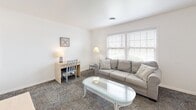 Located at 3 Brentwood Cir in Evansville, Indiana, this thoughtfully designed one-bedroom, one-bathroom unit makes excellent use of its compact single-floor layout. The living room serves as the heart of the space, featuring large windows that invite ample natural light, patterned carpeting, and enough room for comfortable seating and a dedicated workspace or dining area. Clean white walls and neutral tones throughout create a bright, welcoming ambiance. The kitchen is efficiently appointed with white cabinetry, granite-style countertops, a classic subway tile backsplash, a double-basin stainless steel sink, and full appliances including an electric range and overhead microwave. The bedroom offers a generously sized layout with patterned carpet, a natural window, built-in shelving, and a closet, providing practical storage solutions alongside a comfortable retreat. The bathroom is well-finished with warm wood-look vinyl flooring, a glass-enclosed shower stall accented by dark vertical tile, and clean white fixtures. Throughout the unit, the consistent use of light colors, functional design, and thoughtful details come together to create a comfortable and practical living environment.
