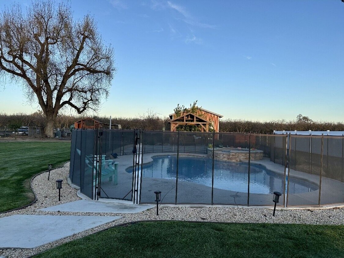 Building Photo - COMING SOON - This stunning 5-Bedroom Home For Rent with Pool, Spa, and Spacious Grounds in a Pea...