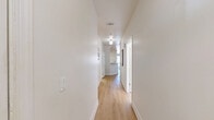 Located at 1047 Tupelo Ct in Charlottesville, VA, this well-appointed 2-bedroom, 3-bathroom residence offers a thoughtfully designed single-floor layout. The living room welcomes you with light-toned hardwood flooring, crown molding, and large vertical blinds that invite generous natural light. The kitchen is a functional highlight, featuring warm cherry wood cabinetry, granite countertops, a peninsula with a built-in sink, and a full suite of stainless steel appliances including a range, microwave, dishwasher, and refrigerator — all set atop neutral tile flooring. A hallway connects the main living areas to the private quarters, maintaining a smooth and organized flow throughout. The spacious primary bedroom is filled with natural light from a wide multi-pane window and is complemented by light hardwood floors and a walk-in closet with wire shelving. The second bedroom is equally bright and comfortable. The three bathrooms are clean and well-finished, with at least one featuring a full soaking tub and shower combination with tile flooring. Throughout the home, a neutral color palette, crown molding details, and light wood floors create a cohesive and inviting ambiance.