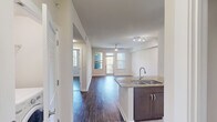 Located at 250 Congress Park Dr in Delray Beach, FL, this well-appointed one-bedroom, two-bathroom residence offers a thoughtfully designed open-concept layout. Dark hardwood-style flooring flows throughout the main living areas, complementing the clean white walls and adding a warm, contemporary feel.

The kitchen is a standout feature, showcasing rich dark cabinetry, gleaming granite countertops, and a full suite of stainless steel appliances including a range, microwave, and refrigerator. A peninsula with a double stainless steel sink seamlessly connects the kitchen to the living area, making it ideal for both cooking and entertaining. The living room is bright and inviting, with access to a private outdoor area via glass doors framed by windows that flood the space with natural light.

The spacious primary bedroom features a ceiling fan, large windows with lush tropical views, and generous closet space with louvered doors. The primary bathroom is well-equipped with dark cabinetry, granite countertops, a wide vanity mirror, tile flooring, and a full soaking tub with shower. A second bathroom provides additional convenience. Built-in shelving in one of the rooms adds practical storage and versatile functionality throughout this efficiently designed Delray Beach residence.