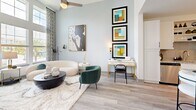 Located in Apopka, FL, this single-floor, one-bedroom, one-bathroom residence offers a thoughtfully designed open-concept layout with modern finishes throughout. The living room is a standout feature, boasting dramatic floor-to-ceiling windows that invite abundant natural light and offer outdoor views, creating an airy, spacious atmosphere enhanced by light wood-style flooring. The kitchen is well-appointed with crisp white shaker cabinetry, a subway tile backsplash, stainless steel appliances, granite countertops, and a large central island with seating — ideal for both meal prep and casual dining. Pendant lighting above the island adds a refined touch. The bedroom is a comfortable retreat, featuring a large window with outdoor views and ample closet space nearby. The full bathroom includes a granite-topped vanity with white cabinetry, a tiled soaking tub/shower combination, and tile flooring. Additional functional spaces include a dedicated laundry area and utility room. Throughout the residence, light-toned wood-style flooring, soft neutral wall colors, and consistent modern hardware create a cohesive and contemporary aesthetic that is both practical and visually appealing.