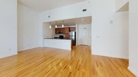 This single-floor, 2-bedroom, 2-bathroom residence offers a thoughtfully designed open-concept layout with a seamless flow between living and kitchen areas. The spacious living room features gleaming hardwood floors and multiple windows that invite abundant natural light, creating a bright and airy atmosphere.

The kitchen is well-equipped with warm-toned wood cabinetry, dark granite countertops, and a full suite of stainless steel appliances, including a refrigerator, electric range, built-in microwave, and dishwasher. Recessed and pendant lighting adds a polished touch, while the open pass-through connects the kitchen to the main living area.

Both bathrooms are finished with tile flooring and wood vanities topped with granite countertops. One bathroom features a walk-in shower with classic subway tile surround, while the second includes a full soaking tub with a tiled surround. The bedrooms are carpeted for comfort, with one offering a walk-in closet fitted with wire shelving for ample storage. A dedicated in-unit laundry room with a full-size washer and dryer adds everyday convenience. Overall, the unit presents a clean, modern aesthetic with practical, functional features throughout.