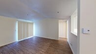 This 590 square foot apartment in Renton, Washington, offers a well-designed living space that maximizes functionality. The single-floor layout comprises one bedroom, one bathroom, and an open-concept kitchen and living area. The primary bedroom, measuring 130 square feet, provides a comfortable retreat with a window allowing natural light.

Throughout the apartment, wood-look flooring creates a warm, cohesive appearance. The kitchen features white cabinetry, contrasting with stainless steel appliances, including a full-size refrigerator and range. Ample counter space and overhead cabinets offer practical storage solutions.

The living area is bright and airy, with large windows that flood the space with natural light. Vertical blinds provide privacy when needed. The bathroom is efficiently designed with a shower/tub combination, toilet, and necessary fixtures.

A hallway and closet contribute to the apartment's storage capacity. The neutral color palette, predominantly white walls, creates a clean, modern aesthetic that can easily accommodate various decor styles. Ceiling fans in some rooms help with air circulation and comfort.

This apartment's layout and features make it an ideal choice for singles or couples seeking a low-maintenance, contemporary living space in an urban setting.