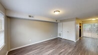 This two-story residence in Columbia, SC is thoughtfully laid out across two floors, offering a well-proportioned living environment with 2 bedrooms and 2 bathrooms. The main floor hosts the living room, dining room, and kitchen, while the upper floor accommodates the bedrooms and additional bathroom. Durable hardwood-style flooring runs throughout the main living areas, complemented by neutral-toned walls and textured ceilings that lend a classic feel to the space. The kitchen features warm wood cabinetry, marble-style countertops, and space for full-sized appliances, providing a functional cooking area. The living and dining areas are bathed in natural light, with a sliding glass door fitted with vertical blinds that opens to a private outdoor patio with views of a fenced yard and mature trees. The bedrooms offer a comfortable retreat; the primary bedroom includes a double-door closet and hardwood-style flooring, while the secondary bedroom is finished with plush carpeting and neutral walls. Two bathrooms serve the home efficiently. A hallway and dedicated closet add to the overall storage and flow of the layout, making this a practical and livable two-floor residence.