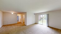 Located at 2700 Boulevard Rd in Elsmere, DE, this two-bedroom, one-bathroom residence offers a practical and well-organized single-floor layout. The combined living and dining area is a bright, open space anchored by neutral carpeting and sliding glass doors that open onto a private balcony overlooking a green outdoor area, allowing natural light to fill the room. A hallway connects the main living space to the kitchen and bedrooms, creating a logical flow throughout.

The kitchen features warm-toned oak cabinetry, white appliances including a refrigerator and electric range, light tile flooring, and a window above the sink that brings in natural light. Ample cabinet storage makes the space highly functional.

The primary bedroom is generously sized, with carpet flooring, a ceiling fan with light fixture, and a built-in closet. The second bedroom also features carpet flooring and a window with blinds, offering a bright and comfortable space. Both bedrooms benefit from good closet storage, with a total of four closets distributed throughout the unit.

The bathroom includes a full tub and shower combination with classic white tile accented by a distinctive blue tile border and geometric pattern, adding a retro character to the space. Overall, this residence provides a comfortable and practical living environment in a convenient Elsmere location.