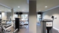 This fitness center is a thoughtfully designed, single-floor facility built to support a comprehensive workout experience. The space is outfitted with a variety of cardio equipment, including treadmills and elliptical machines, as well as strength training apparatus positioned throughout the room. Large windows line the walls, allowing natural light to fill the space and providing views of the surrounding greenery, creating an inviting and energizing atmosphere. Wall-to-wall mirrors are strategically placed to enhance the sense of openness and allow users to monitor their form during exercise. Mounted flat-screen televisions are positioned for easy viewing from the cardio machines, adding an entertainment element to workouts. Recessed ceiling lighting supplements the natural light, ensuring the space remains bright and well-lit at all times. The flooring is finished with a durable, cushioned surface appropriate for fitness use, while the neutral gray and white color palette on the walls contributes to a clean, modern aesthetic. Structural columns divide the space subtly without disrupting the overall flow. Crown molding adds a refined architectural touch, elevating the overall design above a standard gym environment.