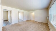 Located at 510 Maloney Road in Poughkeepsie, NY, this single-floor, one-bedroom, one-bathroom unit offers a well-organized and functional layout. The living room is generously sized, featuring soft wall-to-wall carpeting, bright white walls, and a large bay window fitted with horizontal blinds that frame pleasant outdoor views of the surrounding greenery. Baseboard heating runs along the perimeter, and a wall-mounted AC unit provides climate control year-round. An adjacent dining room flows naturally from the living space, continuing the light, neutral aesthetic. The kitchen is equipped with warm honey-toned cabinetry, gray laminate countertops, a mosaic tile backsplash, and a full suite of black appliances including a refrigerator, range, and dishwasher. Light wood-style vinyl flooring adds a clean, modern touch. The bedroom is a comfortable size, featuring carpeted floors, a window with natural light, a ceiling fan, and baseboard heating. Four closets distributed throughout the unit offer ample storage. The full bathroom includes full-height tile surround at the tub/shower, wood-style flooring, a white vanity, and a privacy window. The unit provides a clean, move-in ready living environment in a residential Poughkeepsie neighborhood.