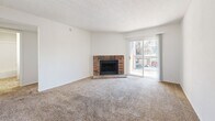 Located at 5020 Glenwood St in Mission, Kansas, this single-floor residence offers four bedrooms and two bathrooms within a well-utilized layout. The living room serves as the heart of the home, anchored by a classic brick wood-burning fireplace and sliding glass doors that open to a private balcony, filling the space with natural light. Soft carpeting extends throughout the living areas and bedrooms, contributing to a warm, comfortable atmosphere. The kitchen is equipped with wood-tone cabinetry, light countertops, a double sink, and a full suite of black appliances including a refrigerator, electric range, dishwasher, and overhead ventilation. Stone-tile flooring runs through the kitchen and both bathrooms, providing a durable and cohesive look. Each bathroom features a tub-shower combination with clean white surrounds. The bedrooms are carpeted and bright, with natural light coming through window blinds, and most include generous closet space with double sliding or bi-fold doors. The primary bedroom provides direct access to one of the bathrooms. A dedicated laundry area adds everyday convenience. Textured ceilings are consistent throughout the unit, completing the traditional residential aesthetic.