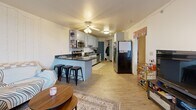 Located at 626 Langdon St in Madison, Wisconsin, this one-bedroom, one-bathroom unit offers a well-organized, efficiently designed single-floor layout. The open-concept living and kitchen area forms the heart of the unit, featuring light wood-tone flooring and a ceiling fan overhead. The kitchen is well-appointed with gray shaker-style cabinetry, dark granite countertops, and a full suite of stainless steel appliances, including a range, over-the-range microwave, and dishwasher. A peninsula with seating provides a practical dining and casual workspace area, seamlessly connecting the kitchen to the living space.

The bedroom is generously proportioned, featuring plush carpeting and a sliding glass door that opens to a private balcony, allowing natural light to fill the room. The balcony offers views of the surrounding neighborhood. The bathroom is clean and functional, with a granite-topped vanity, white cabinetry providing ample storage above the toilet, and a shower-tub combination with a curtain enclosure. Tile flooring completes the bathroom's practical design. Overall, the unit presents a straightforward, functional layout well-suited for residents seeking convenience in a central Madison location.