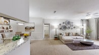 This thoughtfully designed 2-bedroom, 3-bathroom residence in Memphis, Tennessee offers a comfortable and stylish single-floor layout. The open-concept living room features plush carpet, crown molding, a ceiling fan, and large windows dressed with floor-to-ceiling drapes that invite an abundance of natural light. The space flows seamlessly from the living area into the dining and kitchen zone.

The galley-style kitchen is a standout feature, showcasing rich dark espresso cabinetry, granite-style countertops, stainless steel appliances, and durable wood-style flooring. A pantry closet provides additional storage, making the kitchen as functional as it is attractive.

Both bedrooms are carpeted and well-proportioned, with the primary bedroom offering generous space and access to a walk-in closet outfitted with wire shelving and hanging rods. Each bedroom benefits from natural light via large windows with elegant drapery.

The hallways feature wood-style flooring and connect to the three bathrooms, each finished with dark cabinetry, granite-style countertops, and bright vanity lighting. A dedicated closet adds further storage convenience. Neutral gray tones and consistent finishes throughout give the home a cohesive, modern aesthetic.